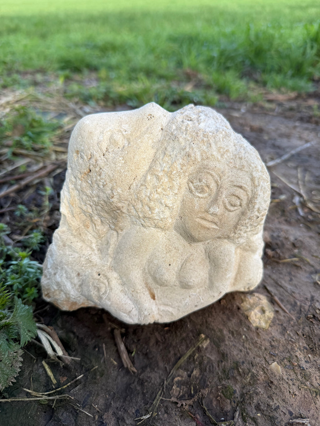Limestone carved woman carrying sheep