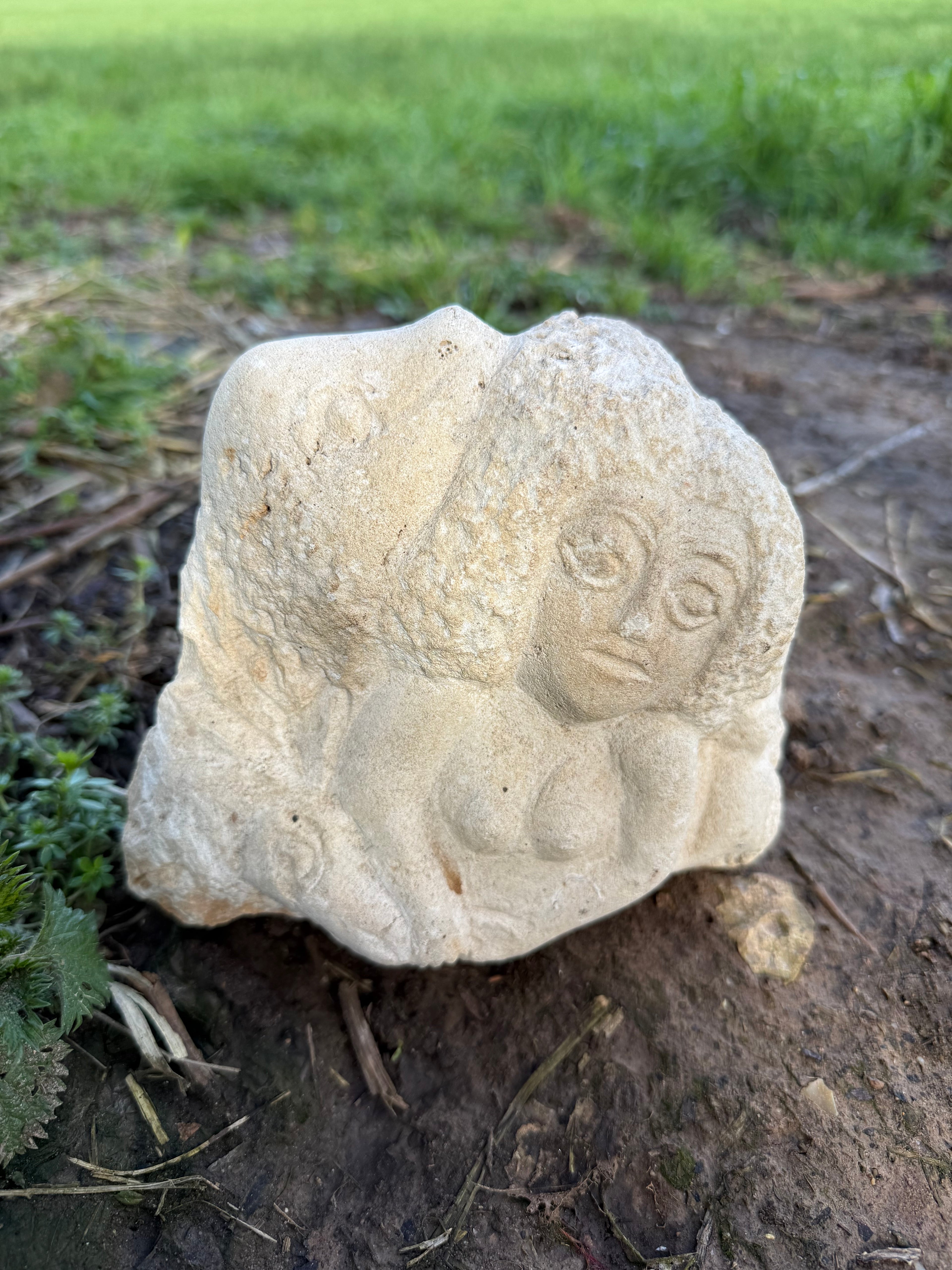 Limestone carved woman carrying sheep