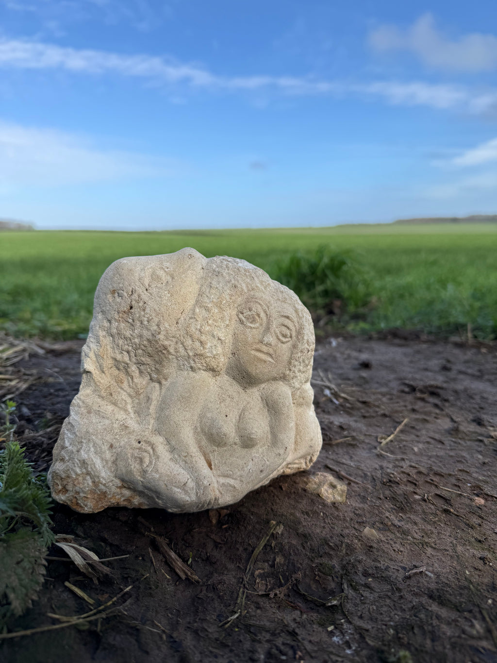 Limestone carved woman carrying sheep