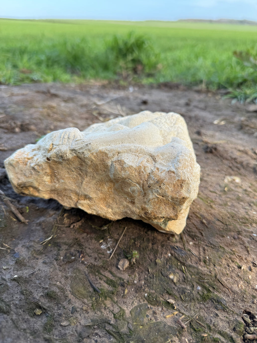 Limestone carved woman carrying sheep